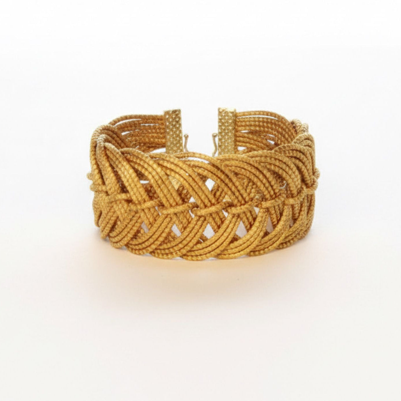 Gold braided bracelet on a white background