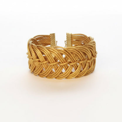 Gold braided bracelet on a white background