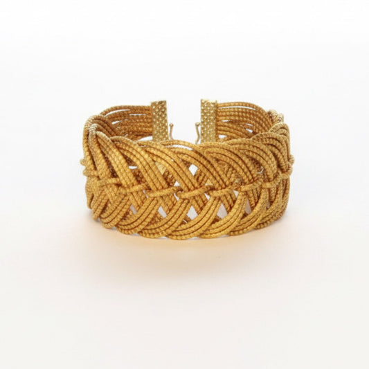 Gold braided bracelet on a white background