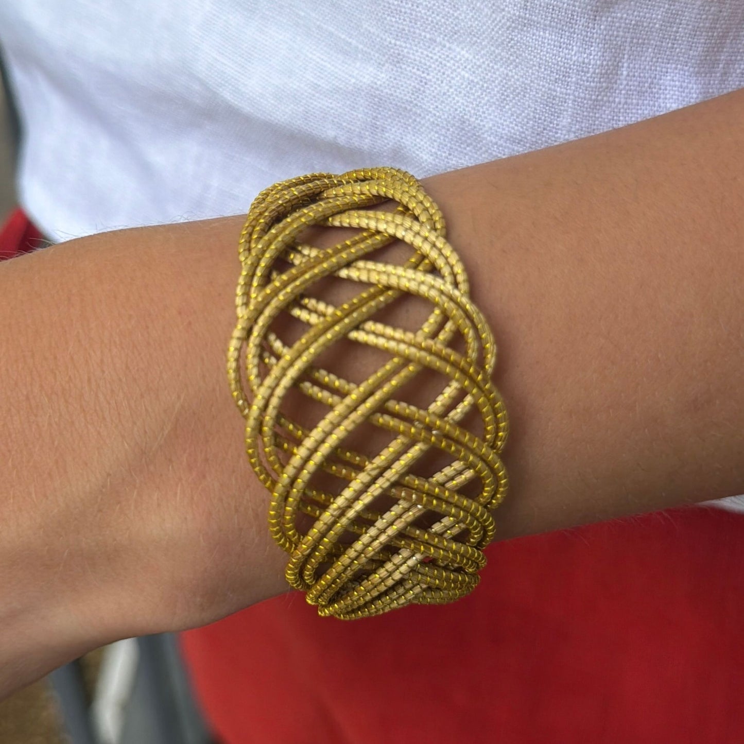 Handwoven golden grass cuff bracelet inspired by flowing sand dunes and natural movement.