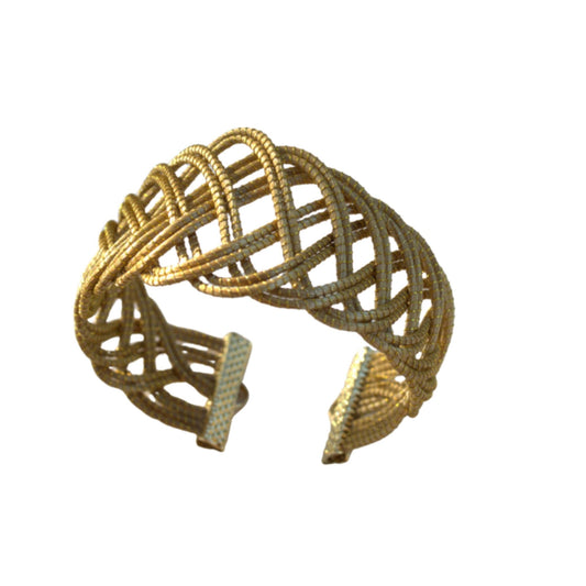 Handwoven golden grass cuff bracelet inspired by flowing sand dunes and natural textures. Lightweight artisan jewelry by HELINN.