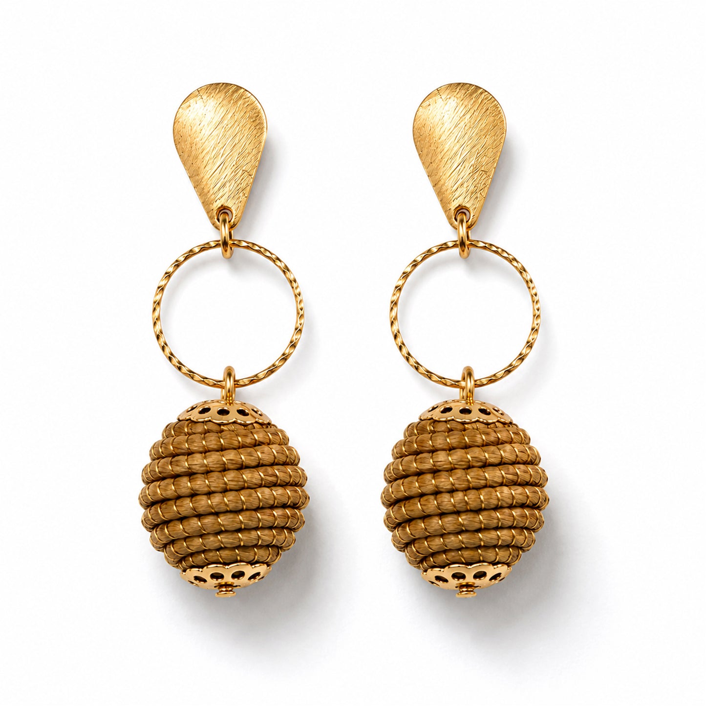 A pair of gold drop earrings with textured teardrop-shaped studs, twisted circular rings, and ribbed spherical dangling charms, shown on a clean white background.