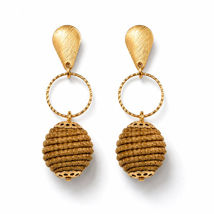 A pair of gold drop earrings with textured teardrop-shaped studs, twisted circular rings, and ribbed spherical dangling charms, shown on a clean white background.