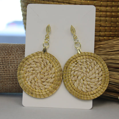 Pair of round woven earrings on a white card with a natural background