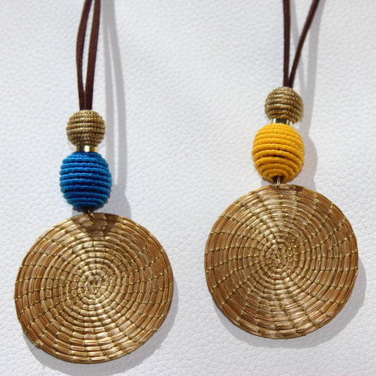 Woven disc pendants with colorful beads on a white background