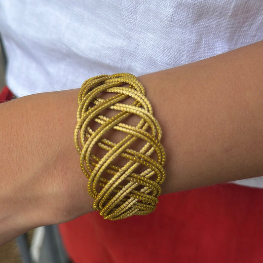 Duna Dourada golden grass cuff bracelet styled with white linen top and red linen pants by HELINN