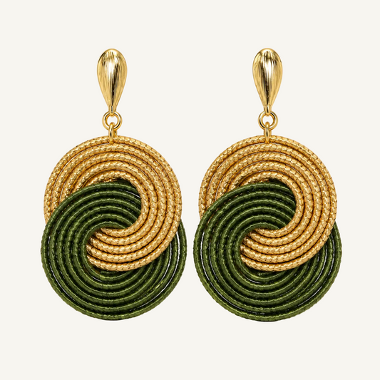 A pair of gold and dark green spiral drop earrings on a clean white background.