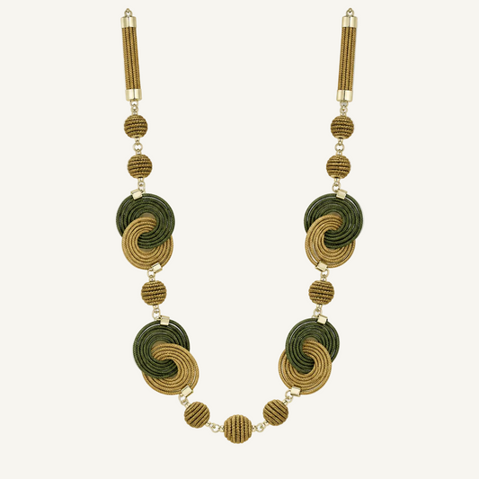 A long beaded necklace featuring alternating large and small spiral motifs in olive green and tan, connected by small gold-toned beads and cylindrical gold-toned end pieces, shown on a plain white background.