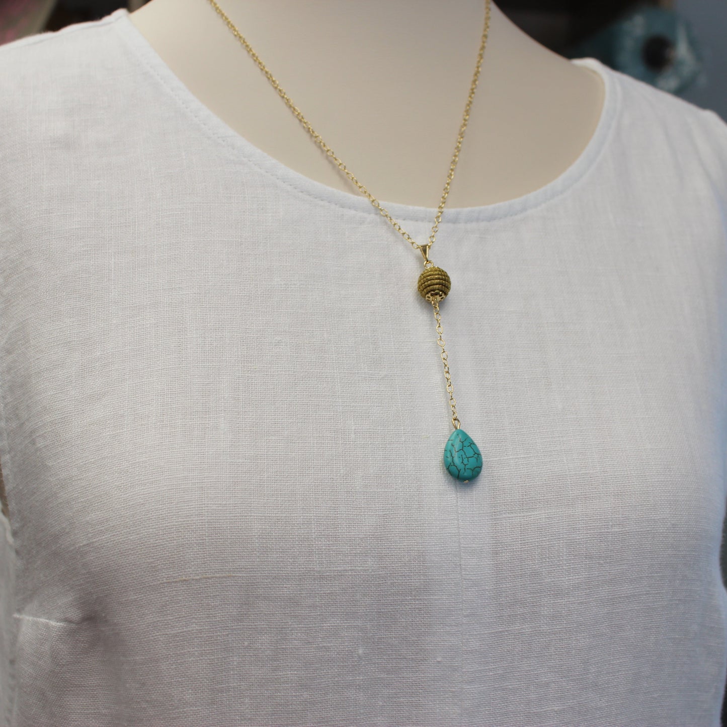 Aura Turquoise Drop Necklace handcrafted with Brazilian Golden Grass, natural turquoise teardrop, and premium 18K gold-plated chain by HELINN.