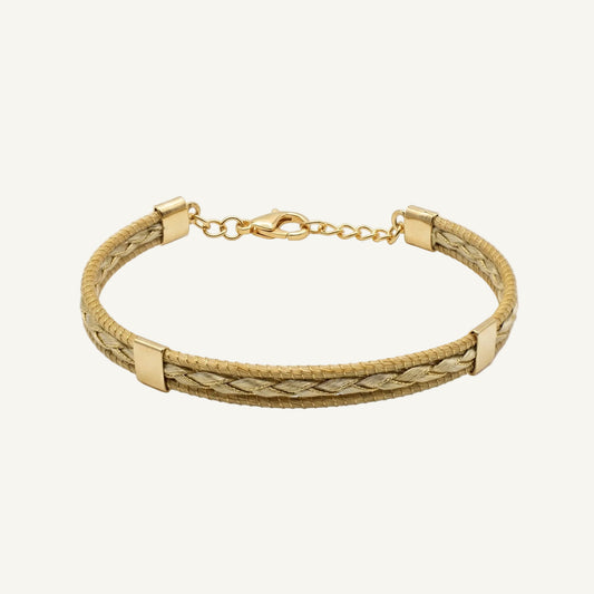 Gold bracelet with braided design on a white background