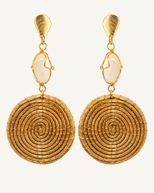 A pair of gold-toned dangle earrings with textured spiral woven disc charms, oval cream stone accents, and hammered top studs, shown on a plain white background.